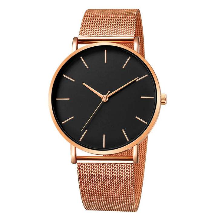 Rose gold wristwatch with black minimalist dial and mesh band on white background