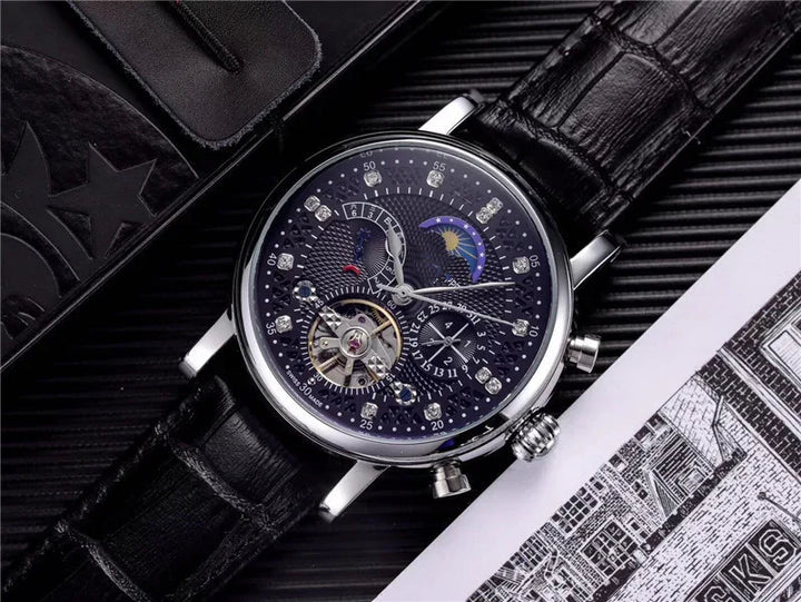 Luxury men's wristwatch with black leather strap, blue dial, diamond markers, and moon phase complication