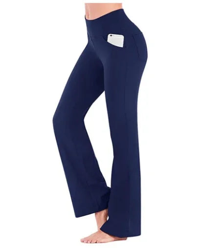 Navy blue high-waisted yoga pants with side phone pocket on model against white background