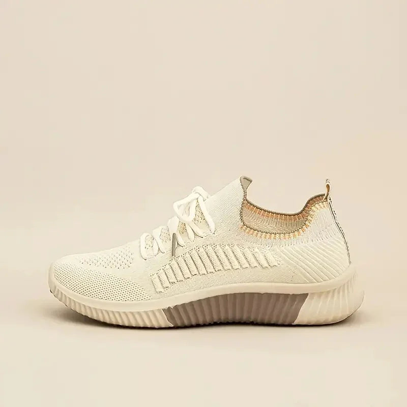 Beige knitted casual sneaker with textured sole and lace-up design on neutral background