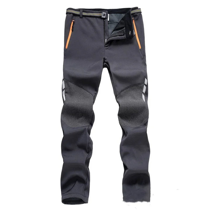 Men's black outdoor hiking pants with reinforced knee patches and orange zippered pockets