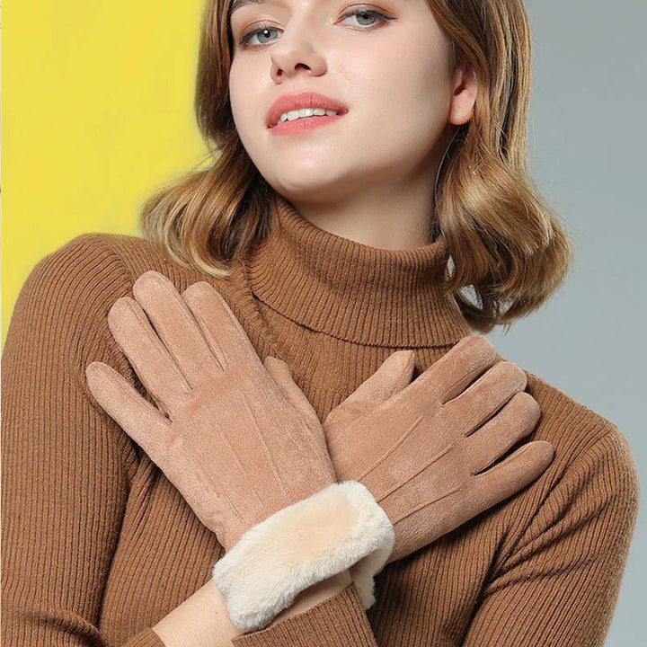 Woman wearing brown suede winter gloves with fur cuffs and brown knit turtleneck sweater