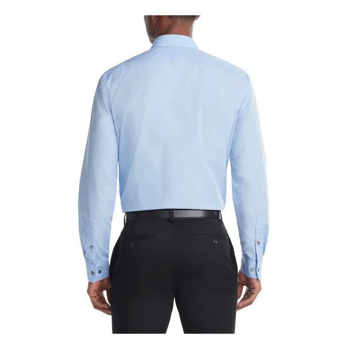 Back view of man wearing light blue dress shirt and black pants with black belt