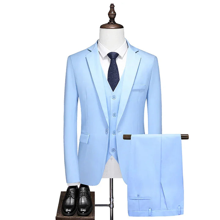 Light blue men's three-piece suit with vest, white shirt, navy tie, and black dress shoes on mannequin