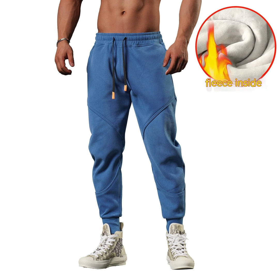 Mens blue fleece-lined jogger pants with drawstring waist and white high-top sneakers