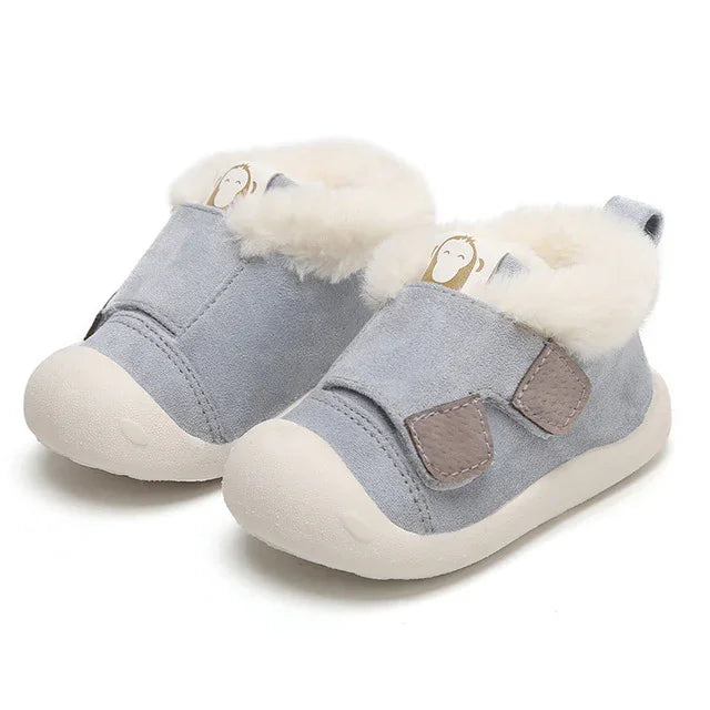 Light blue toddler shoes with white plush lining, beige soles, and velcro straps on white background