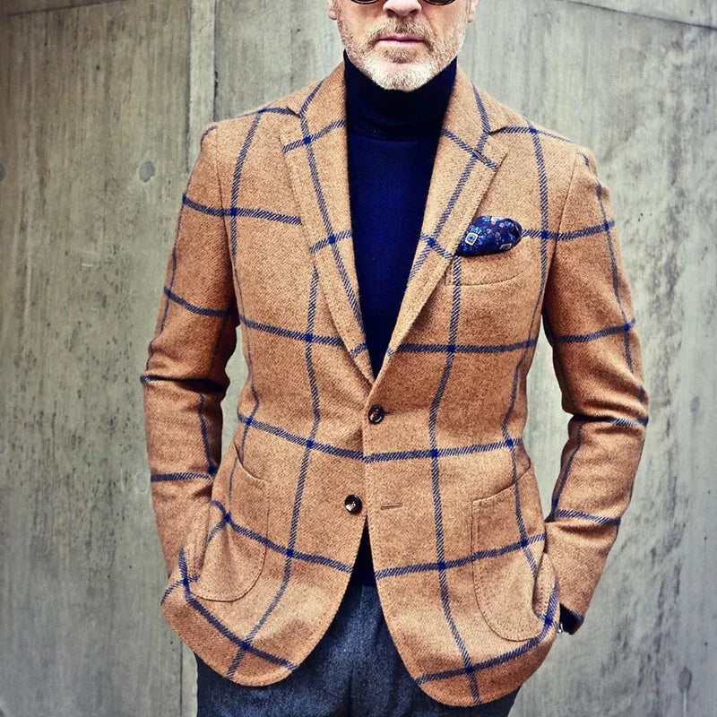 Man wearing tan windowpane check blazer with blue lines, navy turtleneck, and pocket square