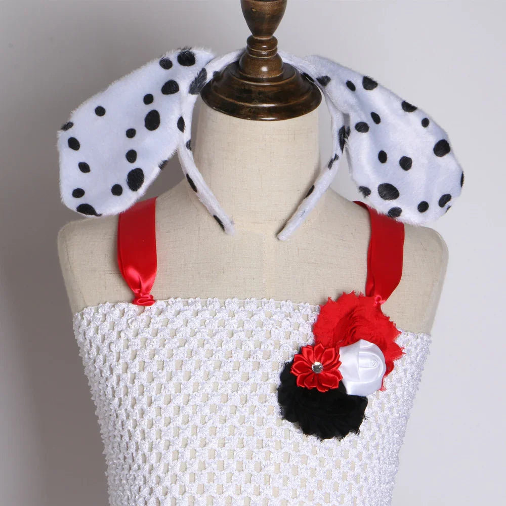White textured dress with red satin straps and floral decoration on mannequin, paired with Dalmatian spotted bunny ears headband