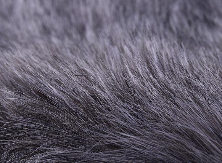 Close-up texture of soft gray faux fur fabric with fine, dense fibers