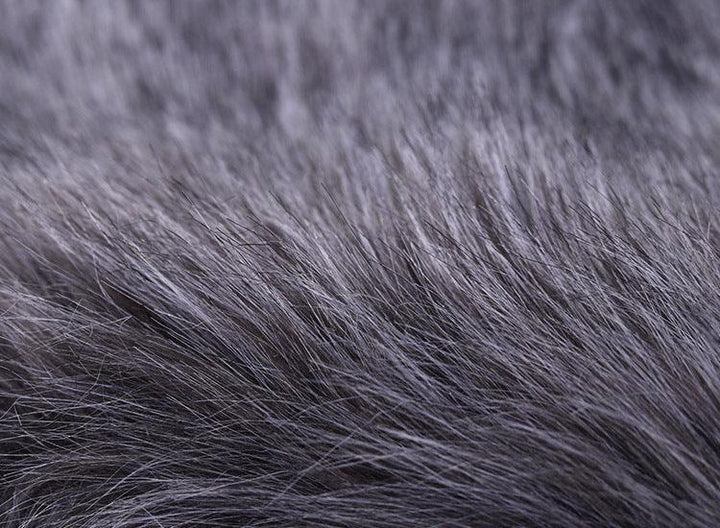 Close-up texture of soft gray faux fur fabric with fine, dense fibers