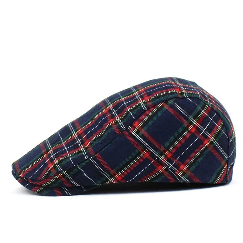 Navy blue plaid flat cap with red, green, and white checkered pattern on white background