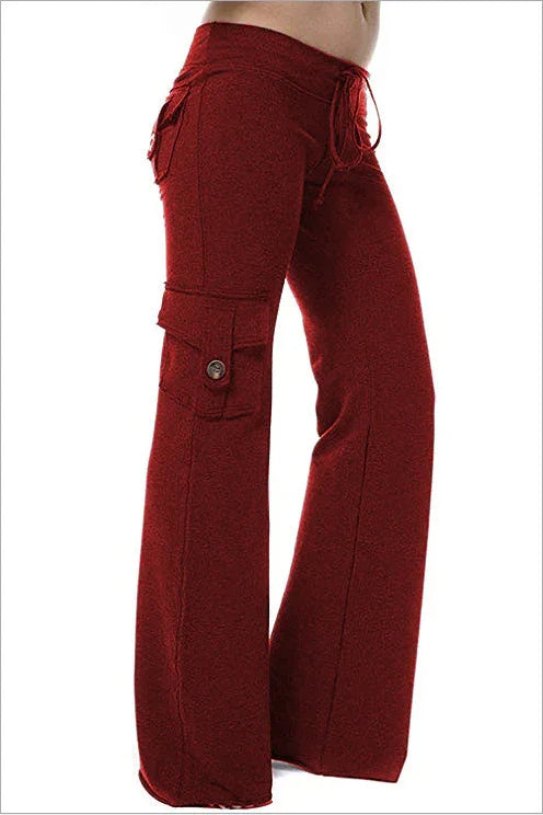 Side view of red wide-leg cargo pants with drawstring waist and buttoned side pocket