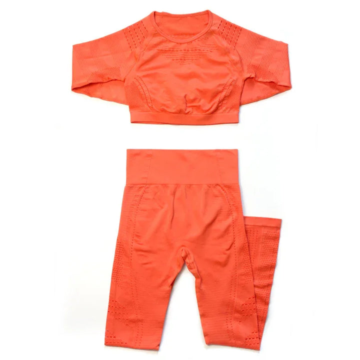 Bright orange seamless long sleeve crop top and high-waisted leggings activewear set with textured patterns