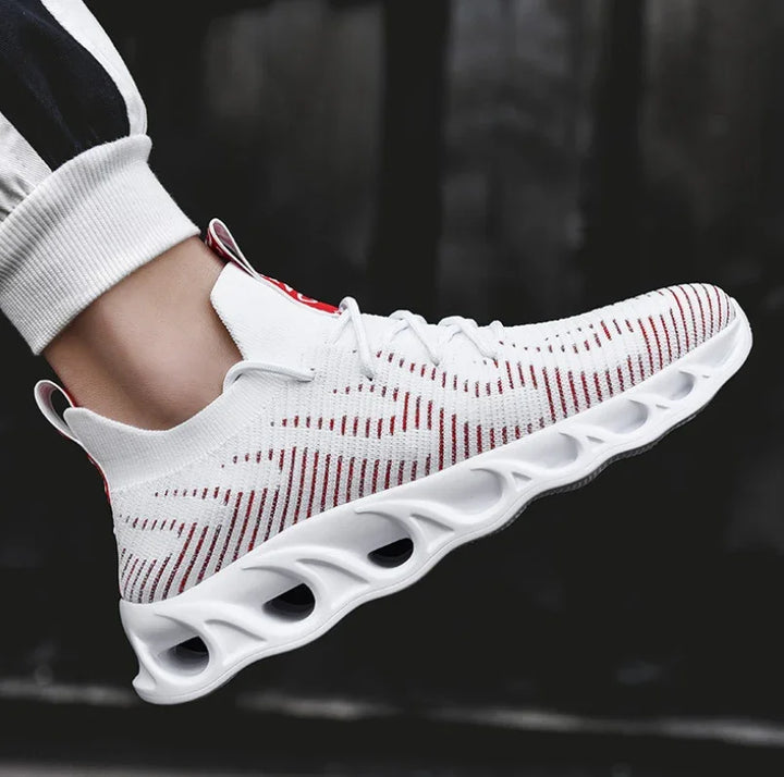 White and red lightweight athletic sneaker with breathable knit upper and unique ventilated sole design