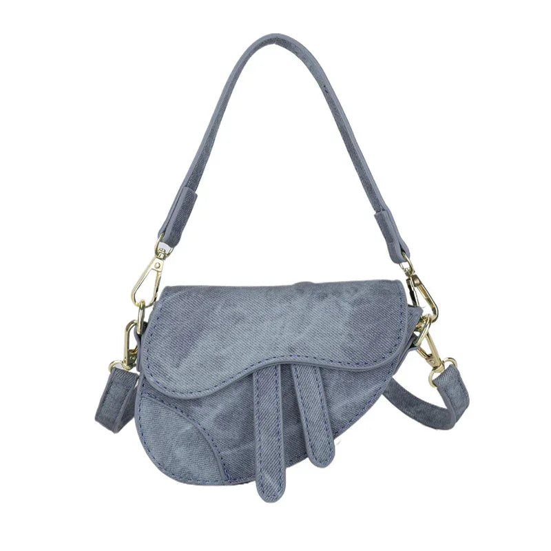 blue suede saddle handbag with adjustable strap and gold hardware