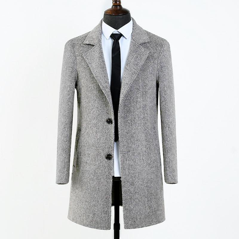 Gray herringbone wool coat on mannequin with white shirt and black tie against white background