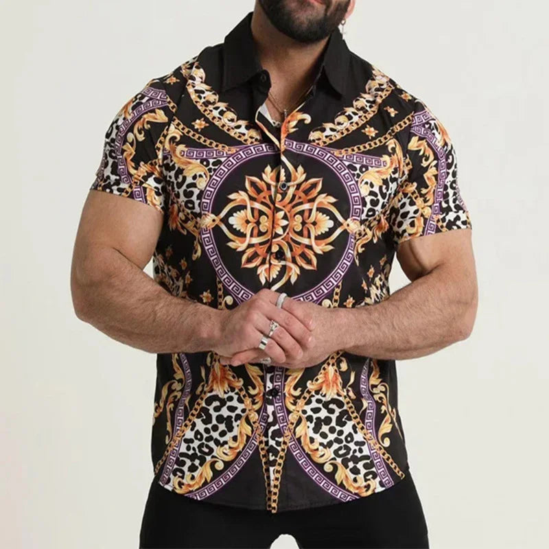 Man wearing a short-sleeve black button-up shirt with gold baroque and leopard print patterns