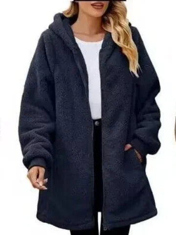 woman wearing black oversized sherpa fleece jacket with hood and zipper front over white top