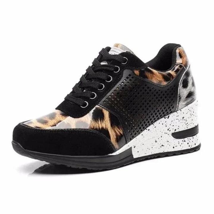Black wedge sneaker with leopard print accents and speckled white sole on white background
