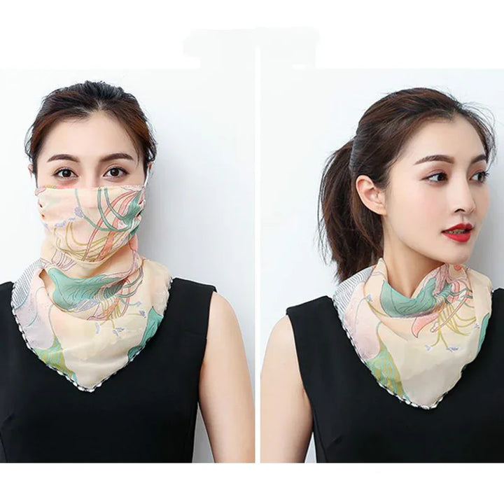 Woman wearing a pastel floral scarf styled as face cover and neck accessory with black sleeveless top