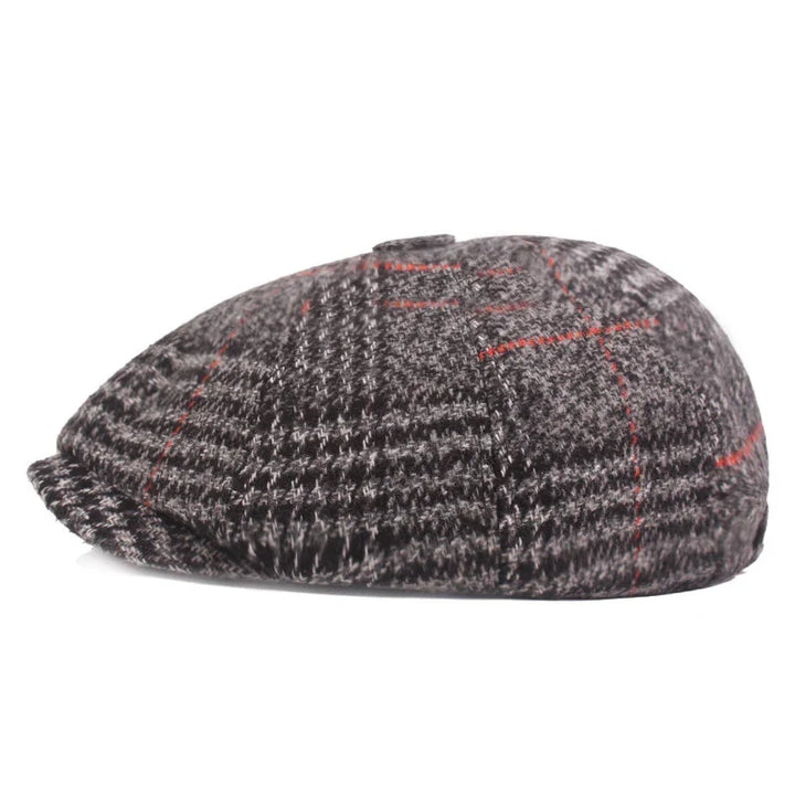 Classic brown and gray tweed flat cap with red check pattern on white background
