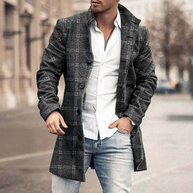 Man wearing grey checkered wool coat, white shirt, and light blue jeans on city street