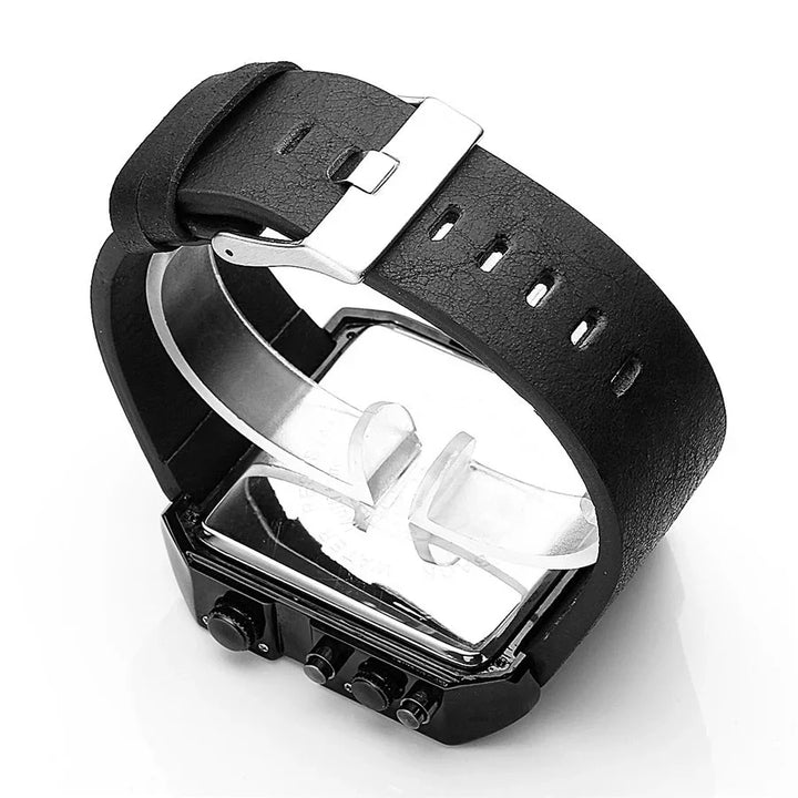 Retro style wristwatch with black leather strap and silver buckle displayed on clear plastic stand