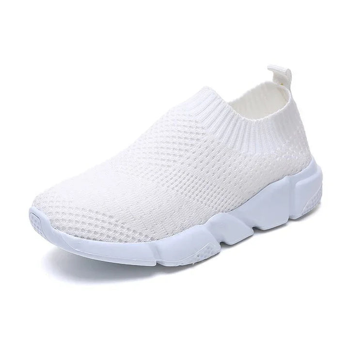 White knit slip-on sneaker with thick segmented white sole and pull tab on heel