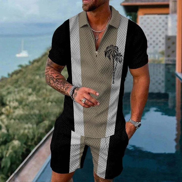 Man wearing black and beige short-sleeve zip polo shirt and matching shorts with palm tree print by pool