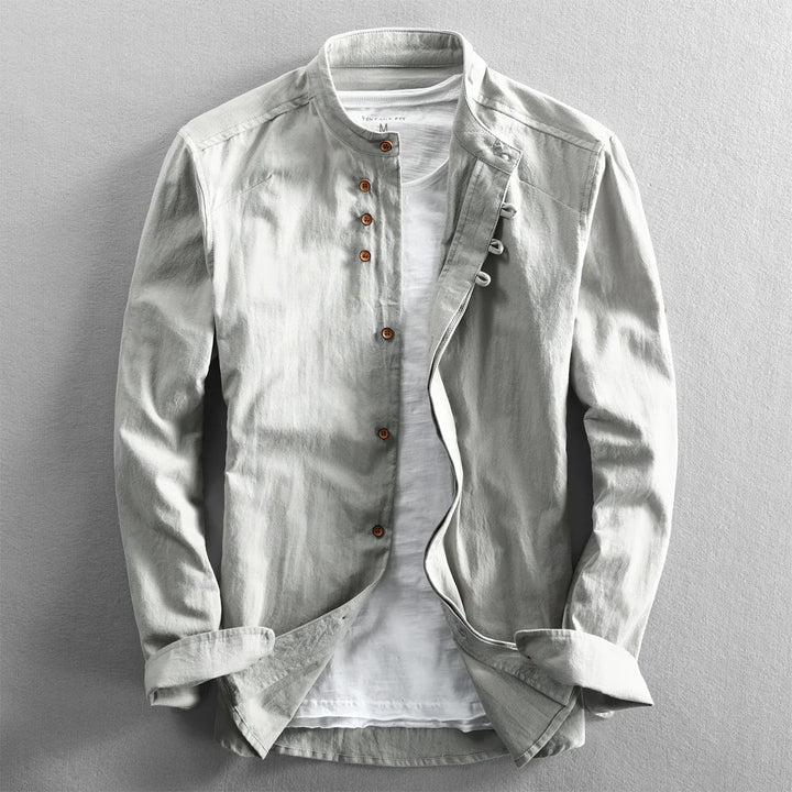 Light gray casual men's jacket with wooden buttons over white t-shirt on gray background