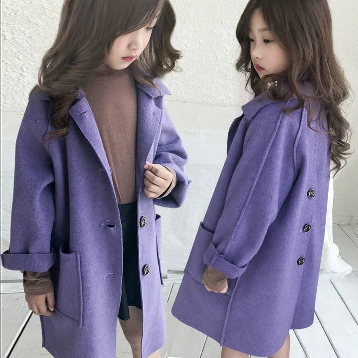 Young girl wearing a purple wool coat over a brown top and black skirt, shown front and back views