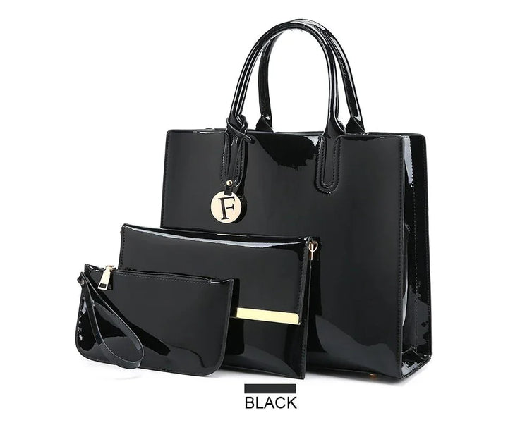 Black glossy handbag set with three pieces including a tote, clutch, and wristlet pouch