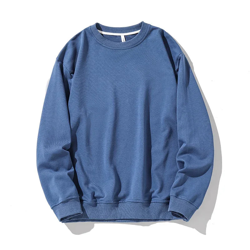Comfortable blue crewneck sweatshirt with long sleeves, ribbed cuffs, and hem on white background