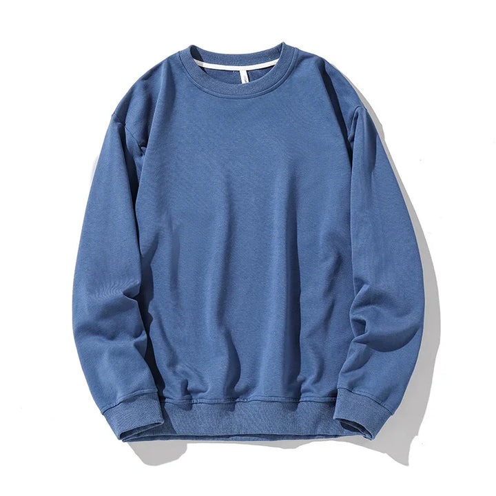 Comfortable blue crewneck sweatshirt with long sleeves, ribbed cuffs, and hem on white background