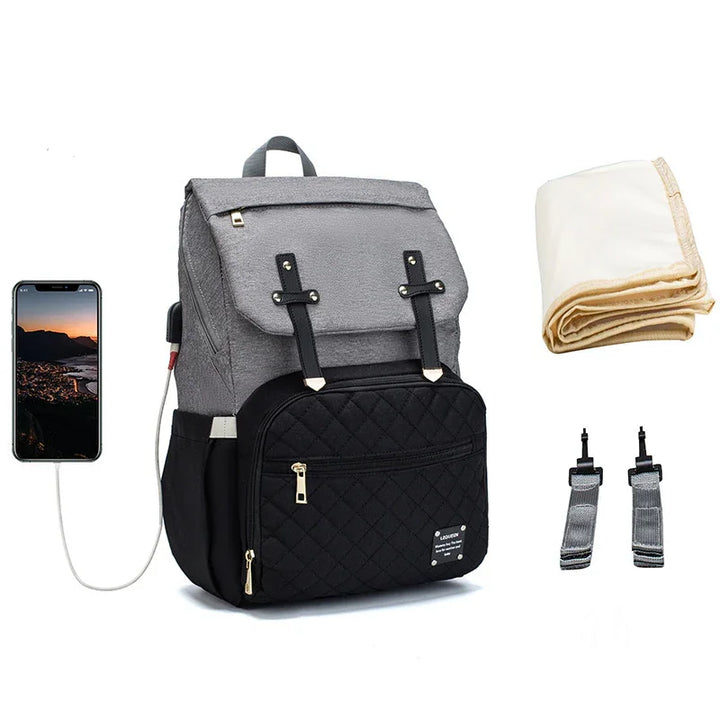 Gray and black diaper backpack with USB charging port, beige changing pad, and stroller straps