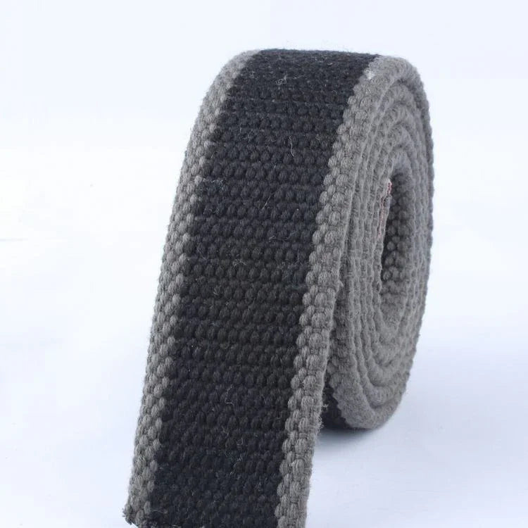 Close-up of rolled black and grey woven belt with textured fabric design
