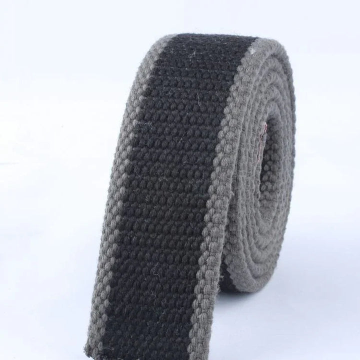 Close-up of rolled black and grey woven belt with textured fabric design