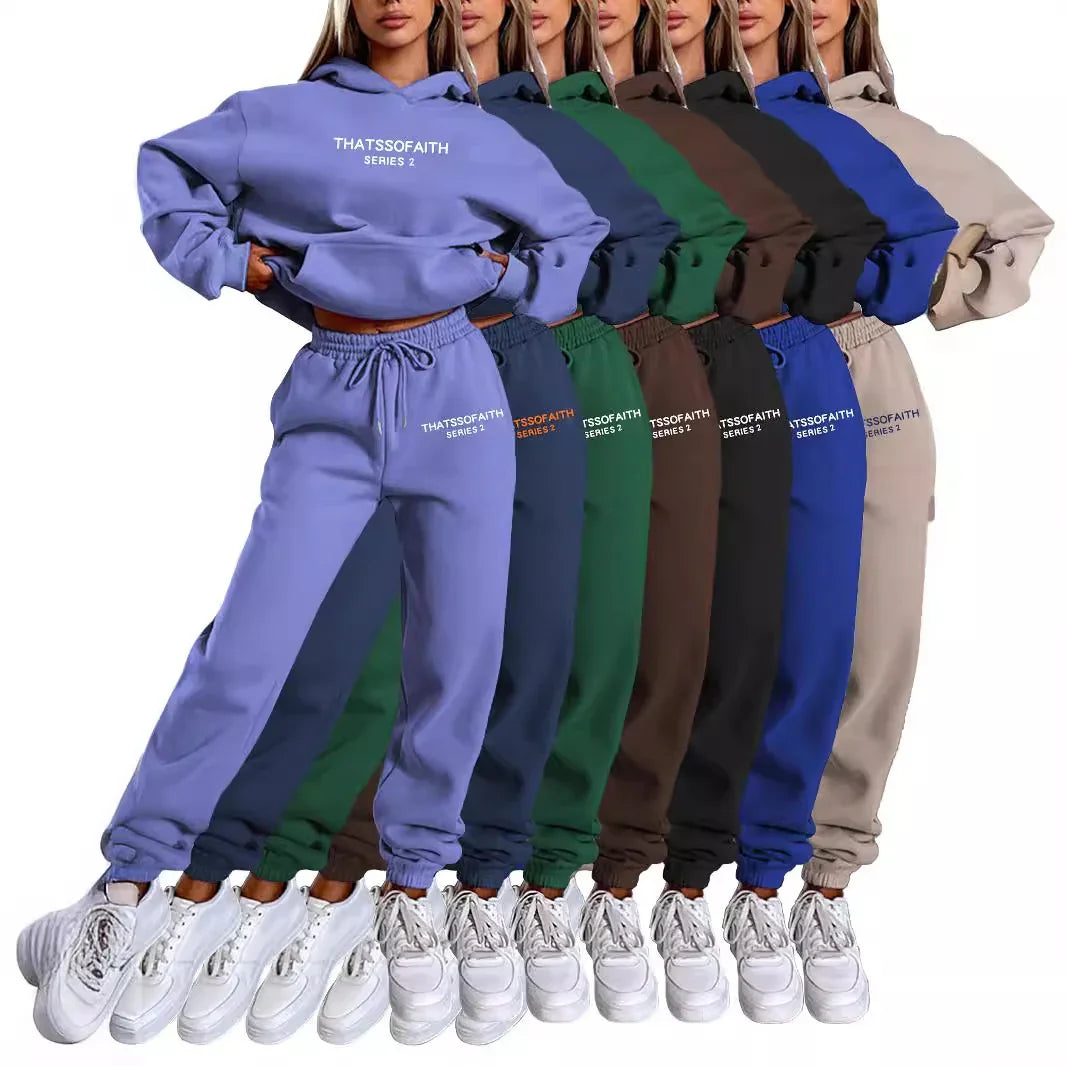 Woman wearing cropped hoodie and jogger pants set in multiple colors with Thatssofaith Series 2 logo and white sneakers