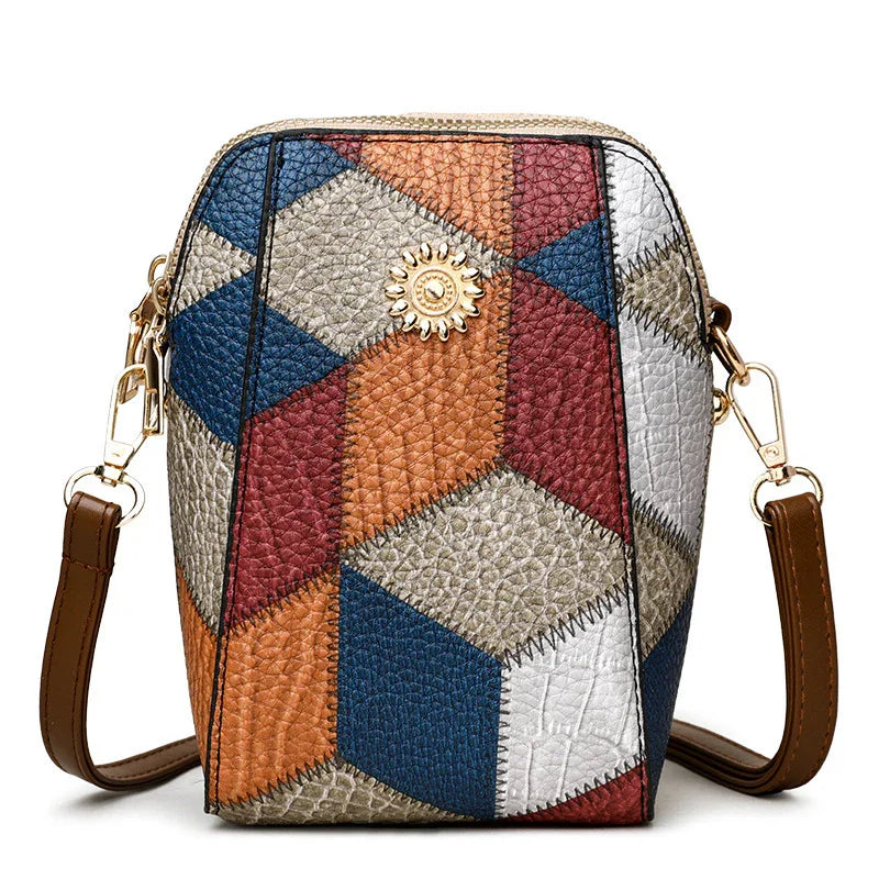 Colorful geometric patchwork leather crossbody bag with gold sun emblem and brown strap