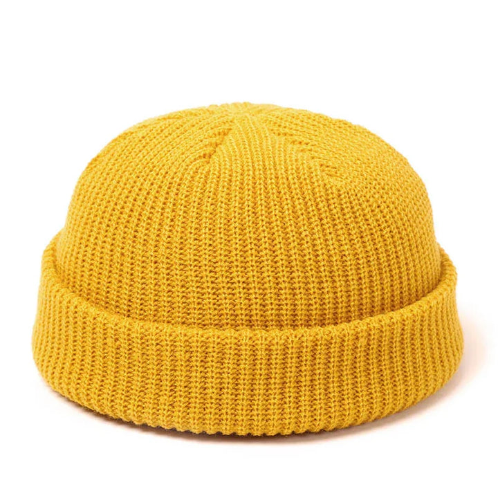 Yellow knitted beanie hat with cuffed edge, isolated on white background