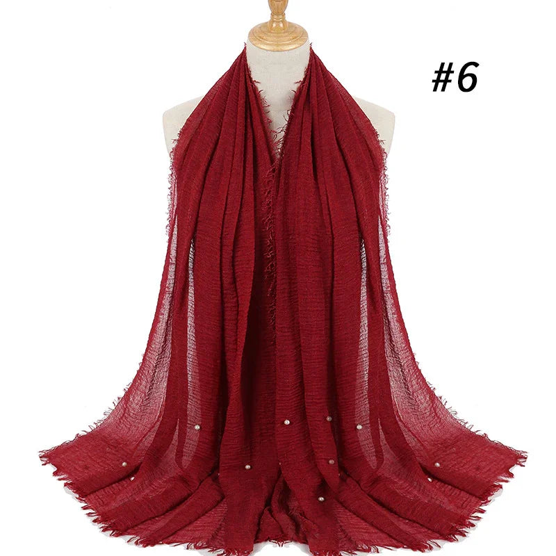 Elegant deep red textured scarf with small pearl accents displayed on mannequin, model #6