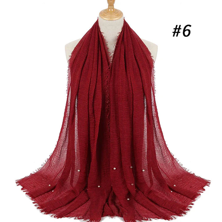 Elegant deep red textured scarf with small pearl accents displayed on mannequin, model #6