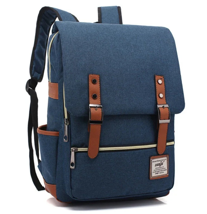 Blue fabric backpack with brown leather straps and front zipper pocket, padded shoulder straps