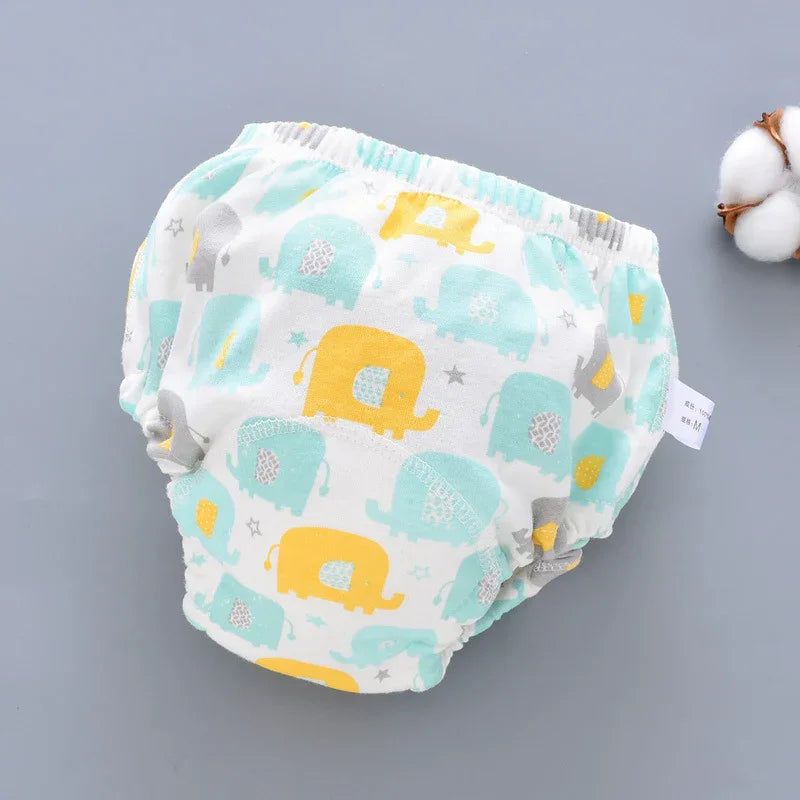 Baby reusable training pants with yellow, blue, and gray elephant print on white fabric