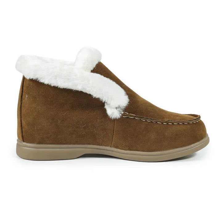Brown suede slipper with white faux fur lining and beige sole on white background