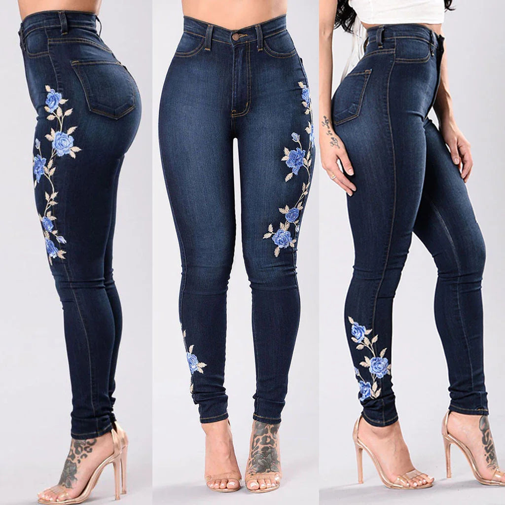 Dark blue skinny jeans with blue floral embroidery on sides worn with clear high heels