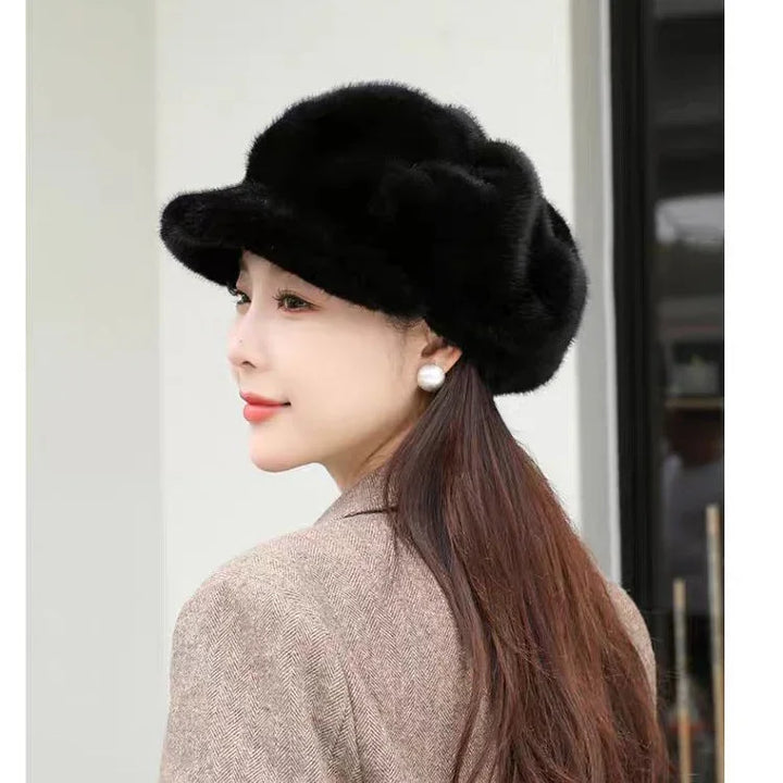 woman wearing black fluffy hat and pearl earrings with brown coat, side profile portrait