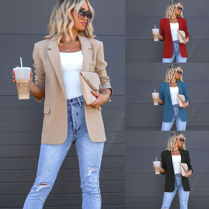 Woman wearing ripped jeans and a blazer in beige, red, blue, and black, holding iced coffee and clutch