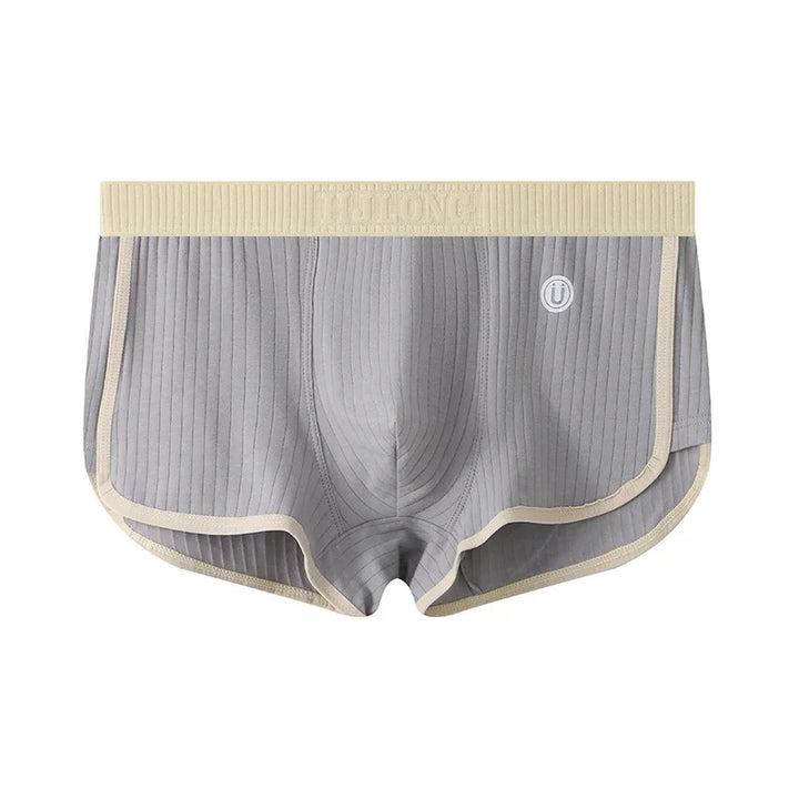 Gray ribbed men's boxer briefs with beige waistband and trim, featuring contoured pouch and small logo