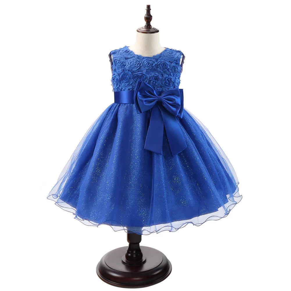 Elegant royal blue sleeveless girls party dress with floral textured bodice and large satin bow